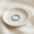 Beaded Spacer Ring in polished stainless steel on a ceramic dish