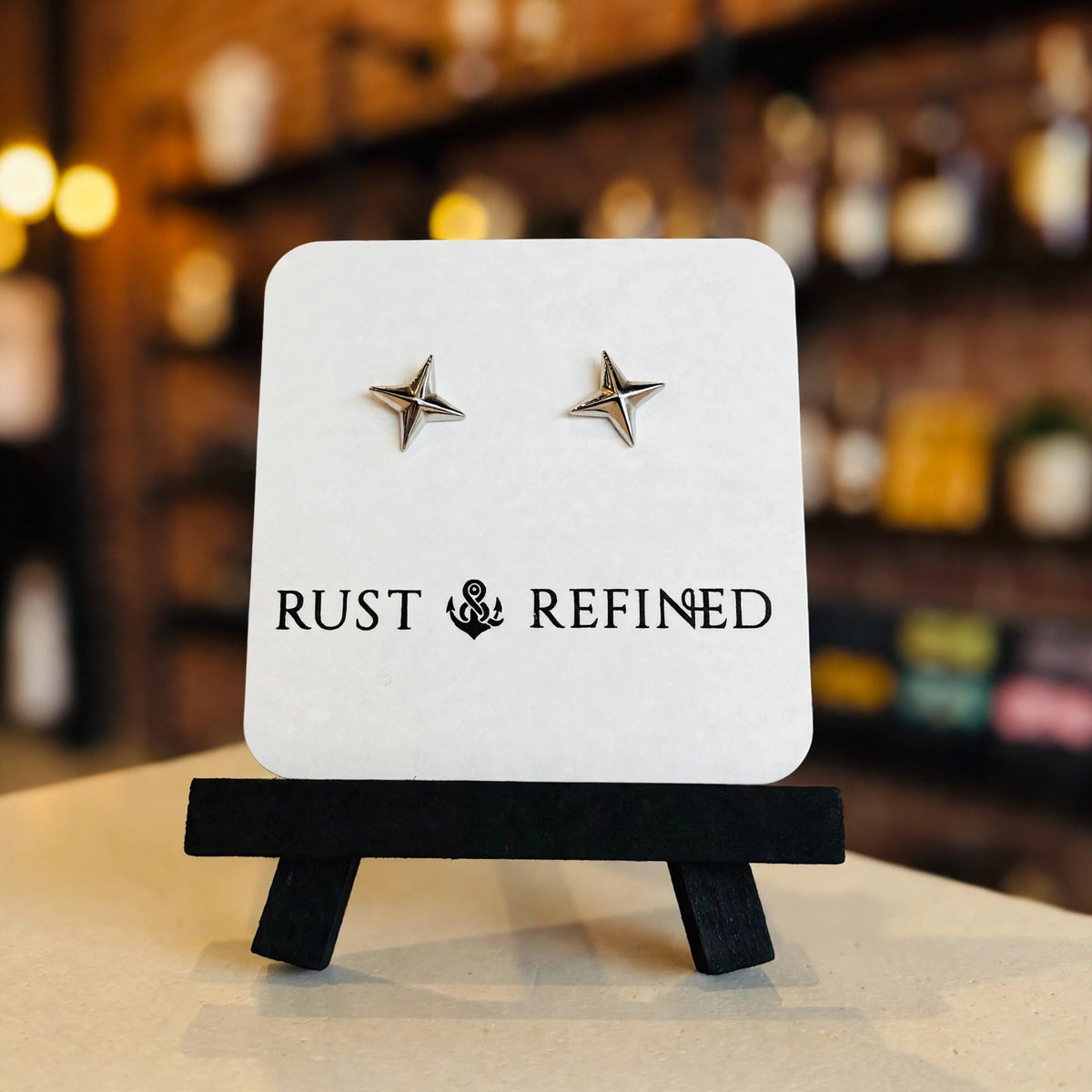 Silver star stud earrings on a Rust & Refined card