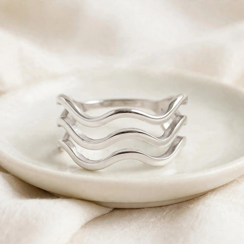 Triple Wave Ring in polished stainless steel on a ceramic dish