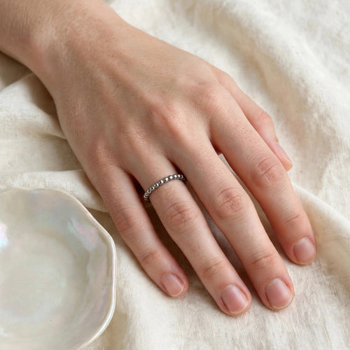 Beaded Spacer Ring in polished stainless steel worn on a woman's hand