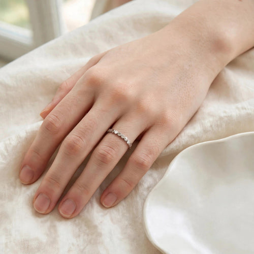 Flat Circle Stacking Ring in polished stainless steel worn on a woman's hand