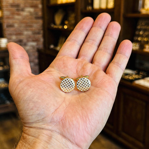 Gold Basketweave Cufflinks held in hand for scale
