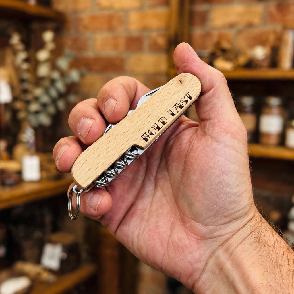Hold Fast Engraved Pocket Knife held in hand for scale