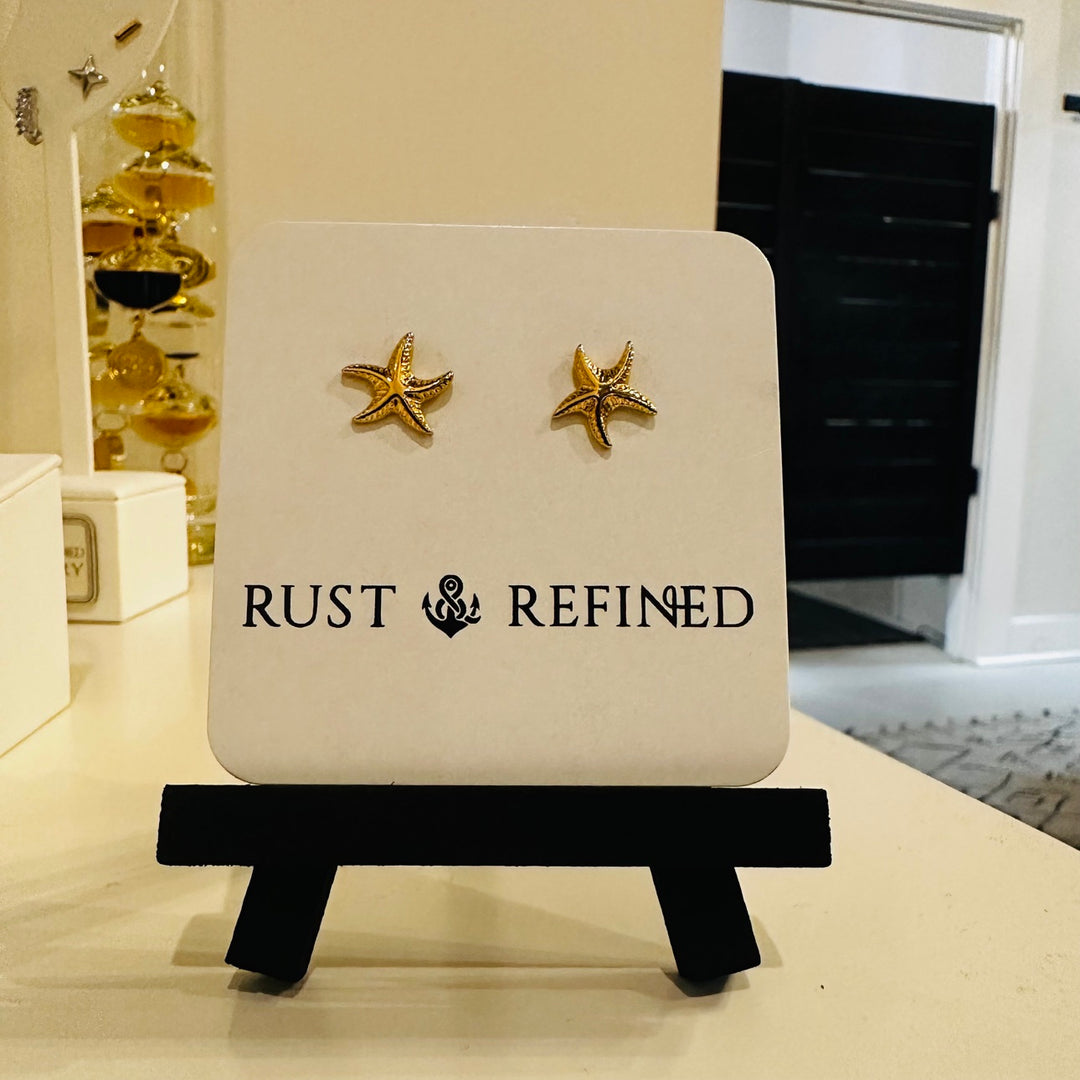 Gold starfish stud earrings on Rust and Refined card
