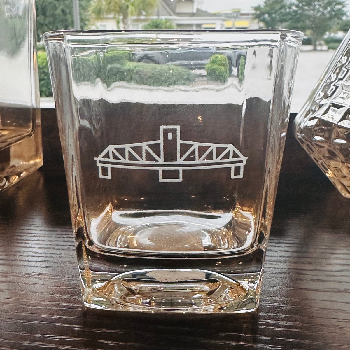 Whiskey glass with etched Surf City swing bridge