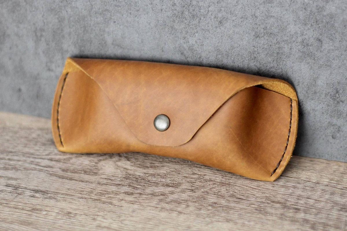 Leather Glasses Case in tan on a wood surface