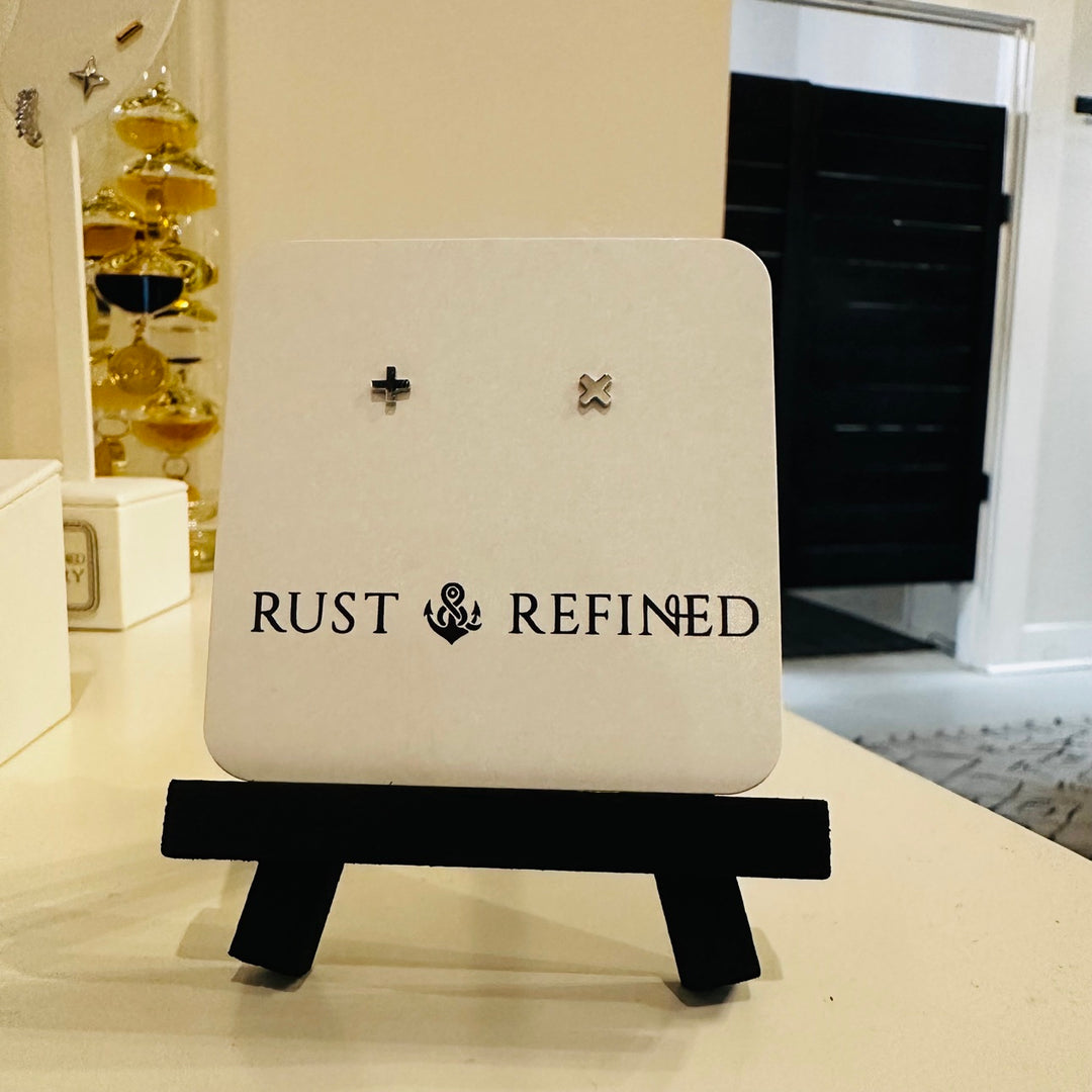 Silver plus and X stud earrings on Rust and Refined card