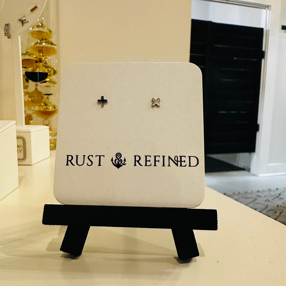 Silver plus and X stud earrings on Rust and Refined card