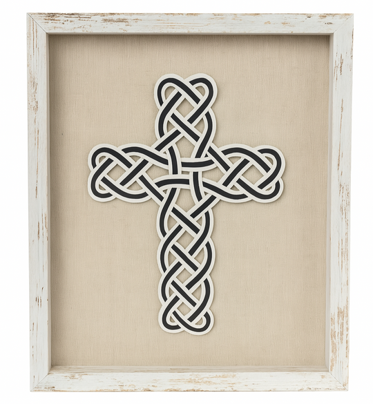 Decorative cross with Celtic knot design in a white frame on a beige background