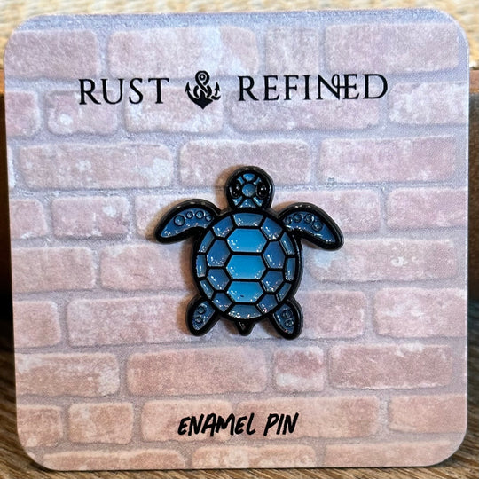 Blue turtle enamel pin on a 'Rust & Refined' branded card with a brick pattern.