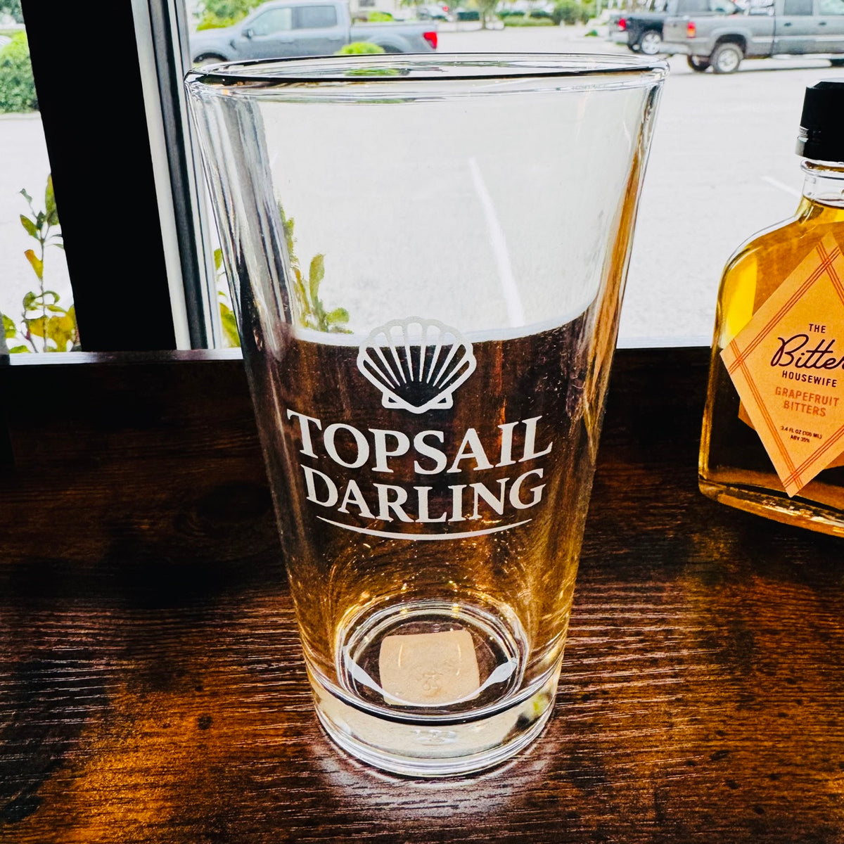 Topsail Darling pint glass with shell logo