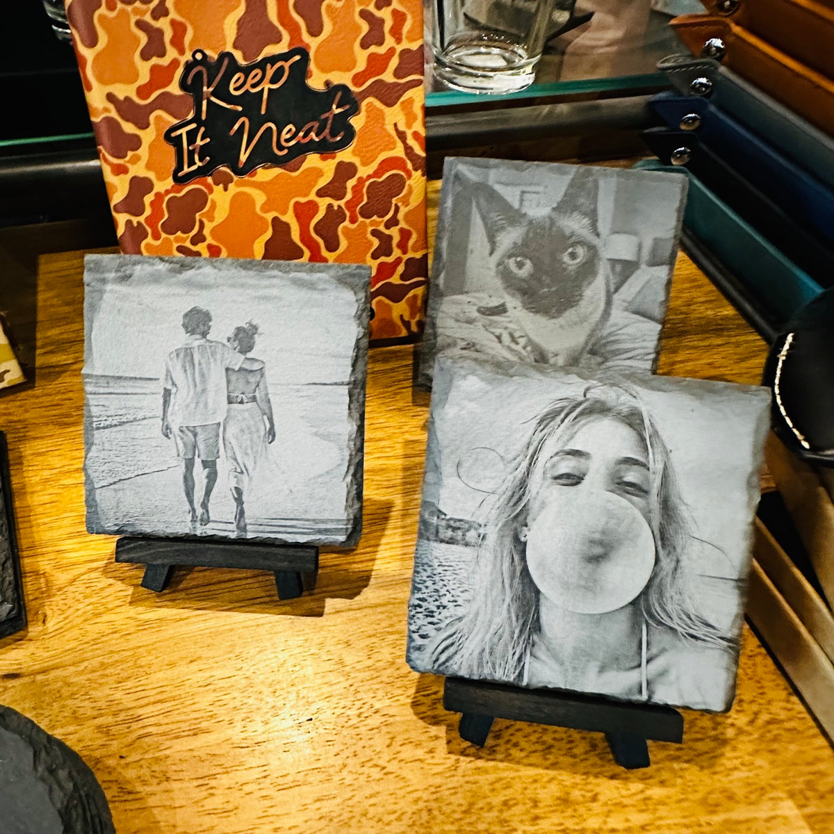 Three custom photo slate coasters on mini easels showing a couple on the beach, a Siamese cat, and a girl blowing a bubble gum bubble