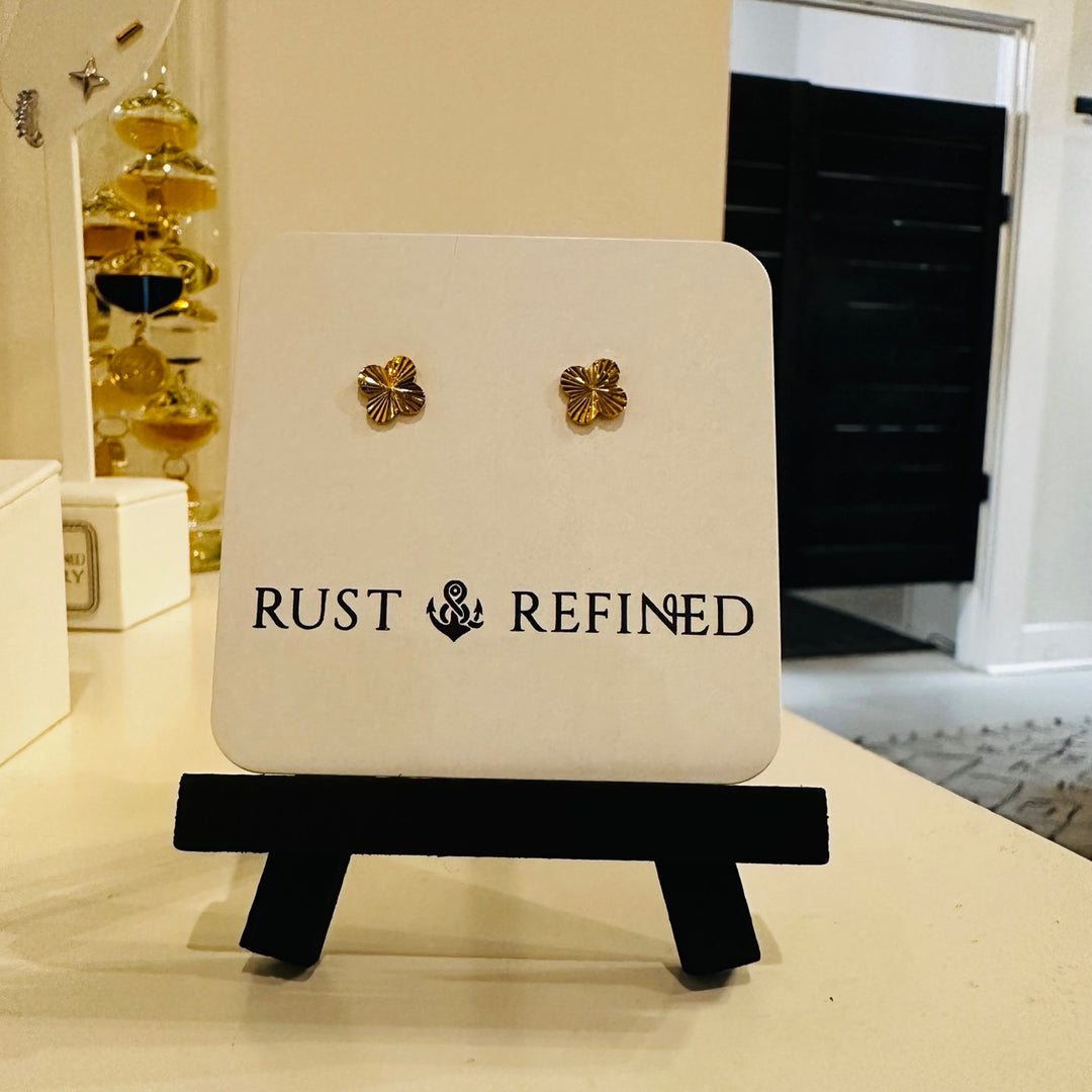 Gold flower stud earrings on Rust and Refined card