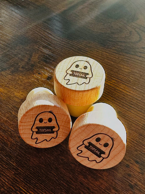 Custom engraved wine stopper for the best dad, held next to a wine bottle