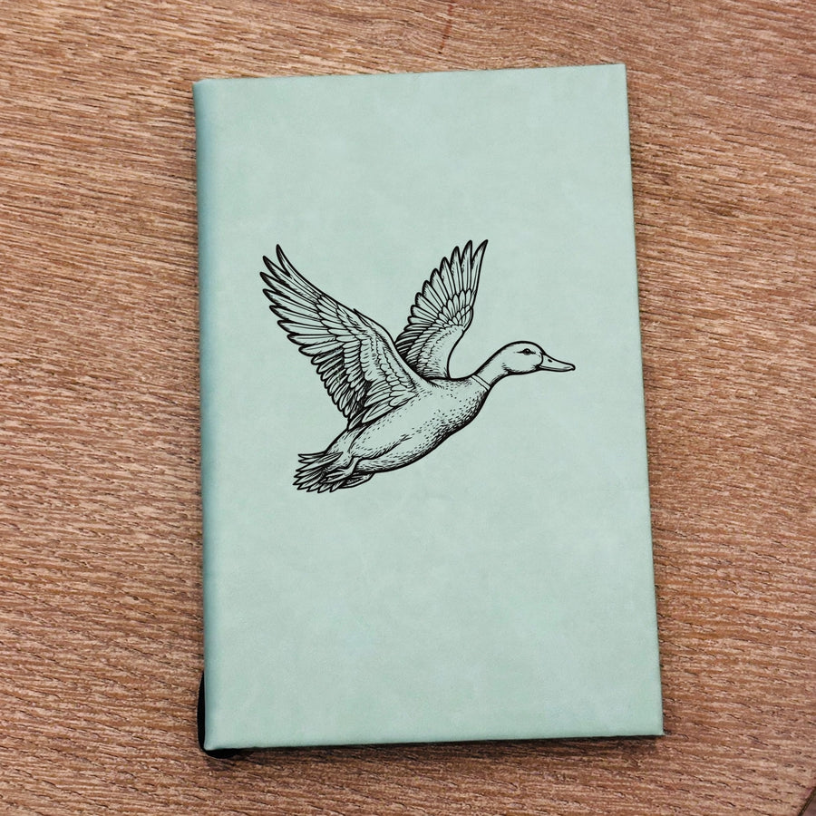 Teal journal with engraved duck in flight