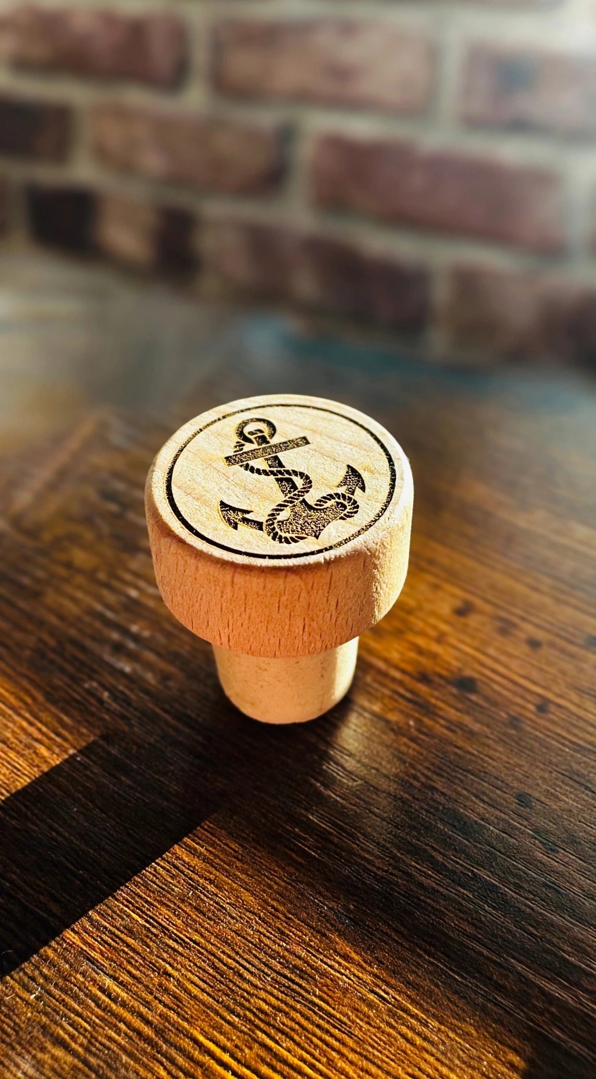 Anchor Wine Stopper on a dark wood counter