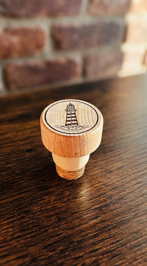 Lighthouse Wine Stopper on a dark wood counter