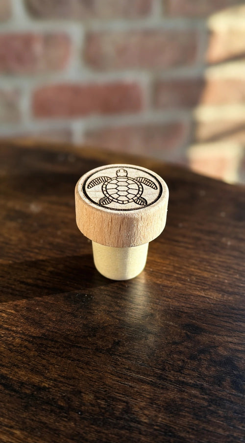 Sea Turtle Wine Stopper on a dark wood counter