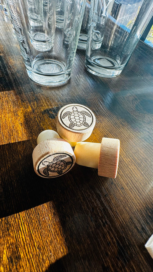 Sea Turtle Wine Stopper, engraved wood stoppers on a dark wood counter