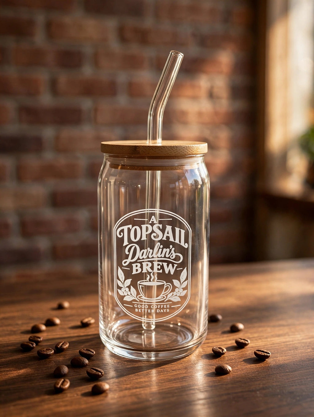 Topsail Darlin's Brew can glass on a dark wood counter with coffee beans, brick wall behind